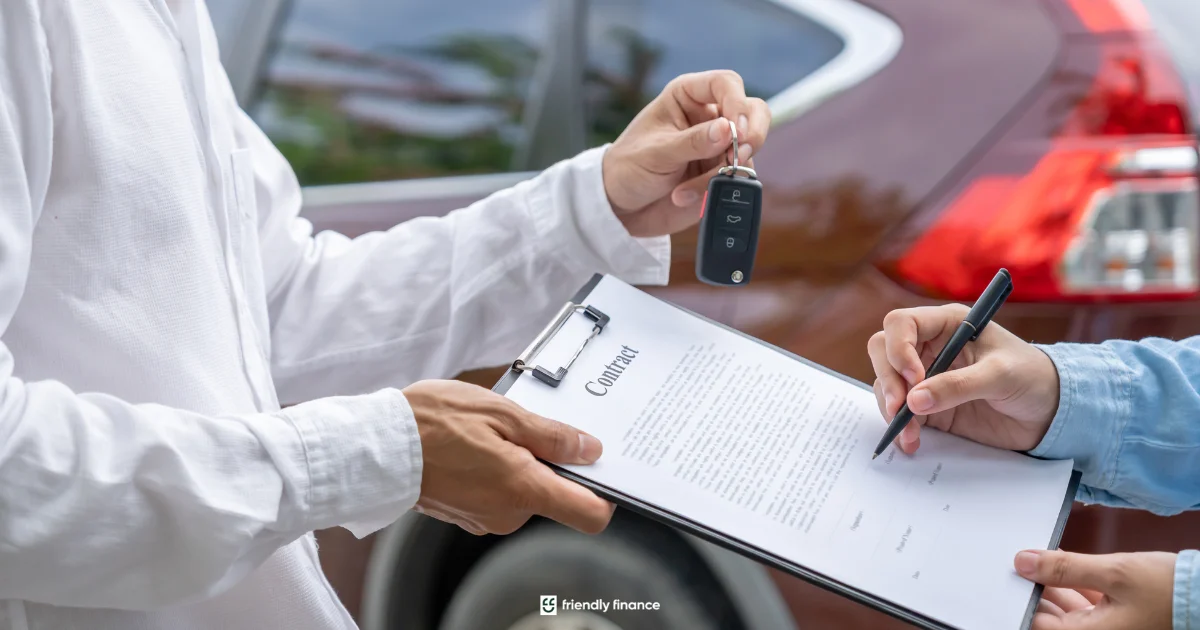 A person signs a car purchase contract on a clipboard while simultaneously receiving a car key, with a blurred red car in the background.