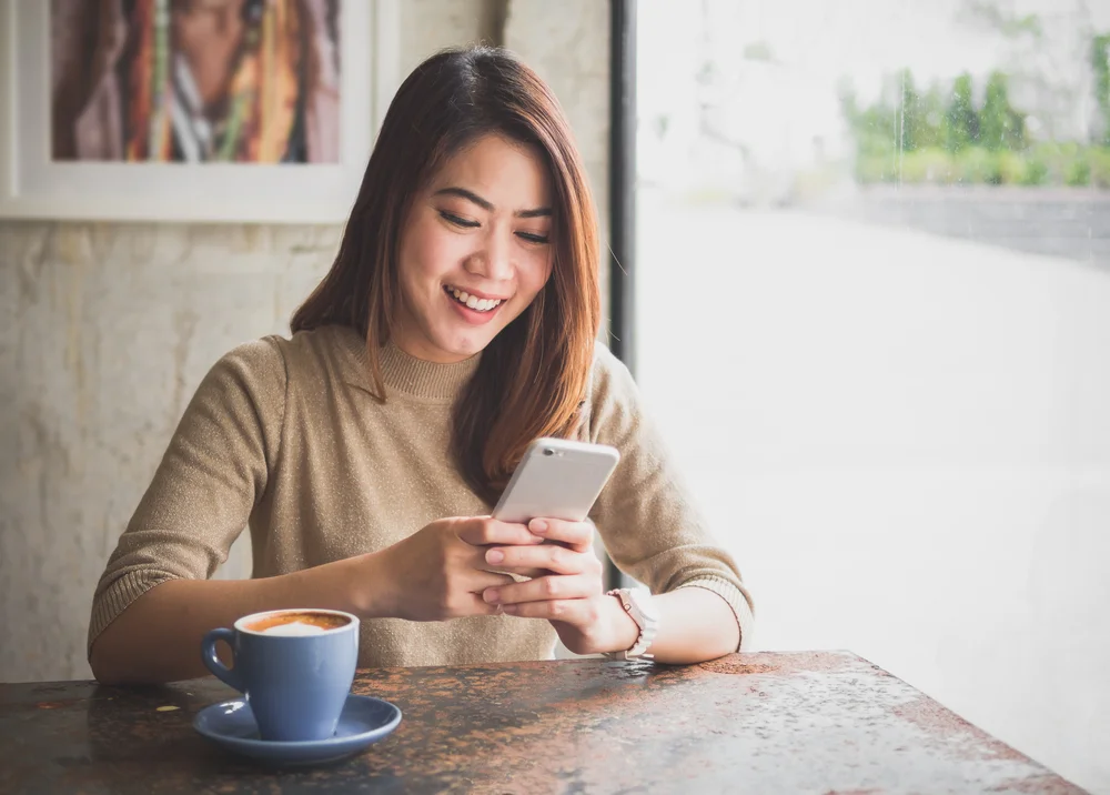happy person looking at ways to earn money online on their phone