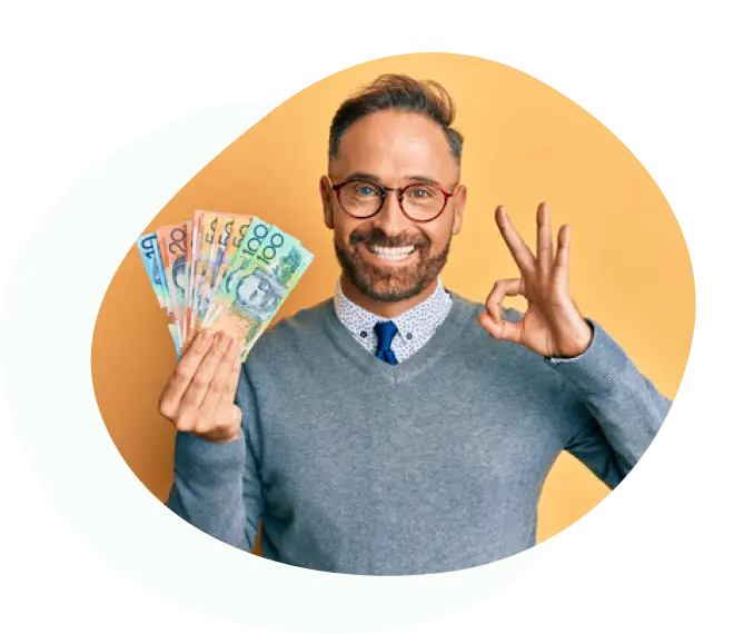 Smiling man holding Australian cash and making OK hand gesture
