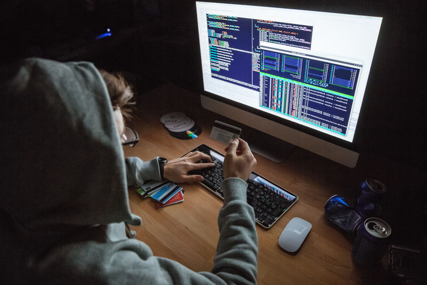 A hacker using stolen credit cards